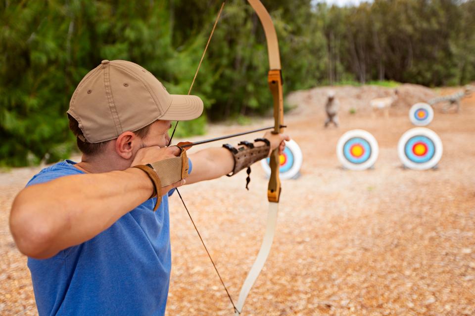 Man using a bow and arrow