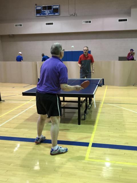 Two people playing table tennis