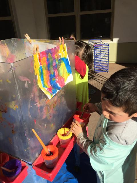 Tot painting on easel