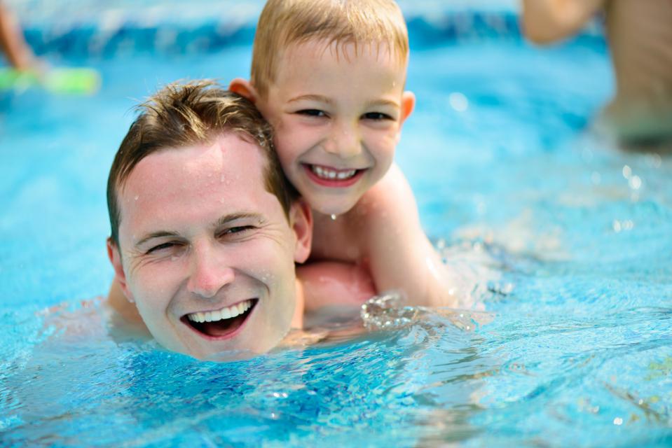 Adult and kid in swimming pool