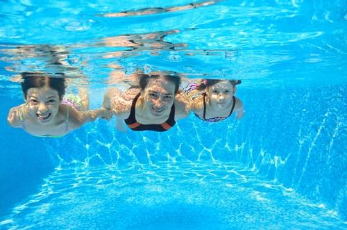Women and children swimming in a pool