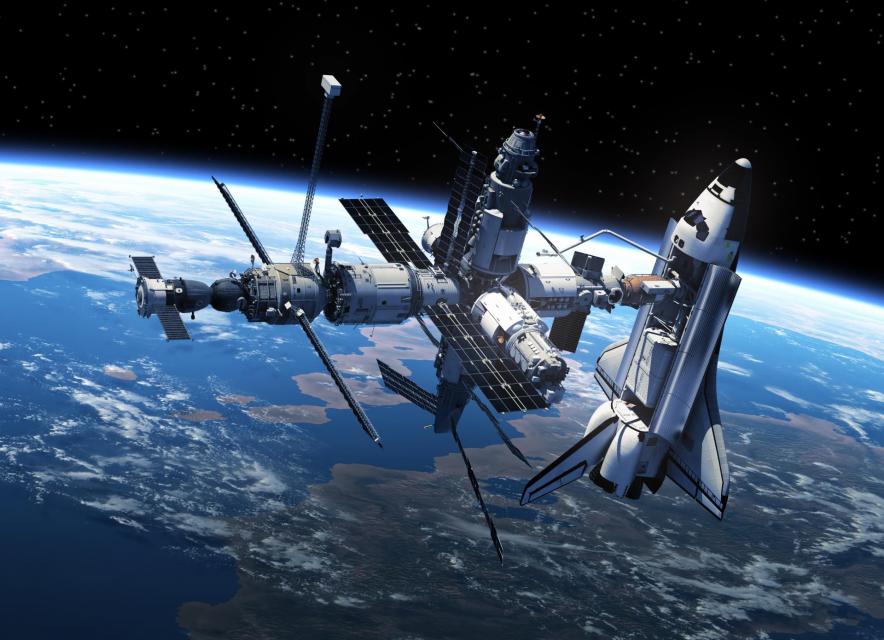 Space shuttle and space station in space
