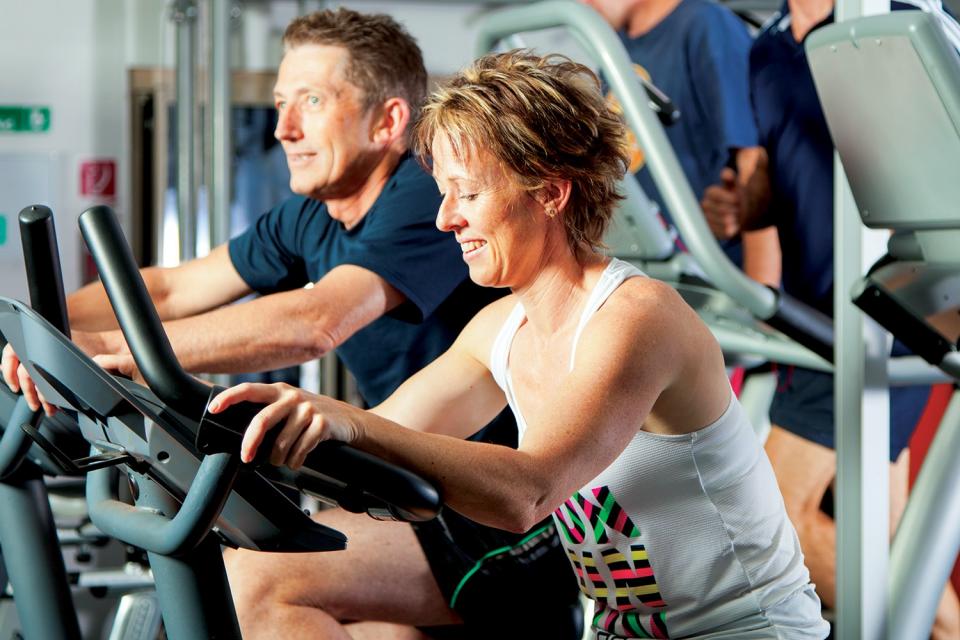 Couple working out on stationery bicycles