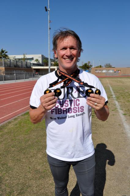 Proud Athlete Shows His Many Medals Won