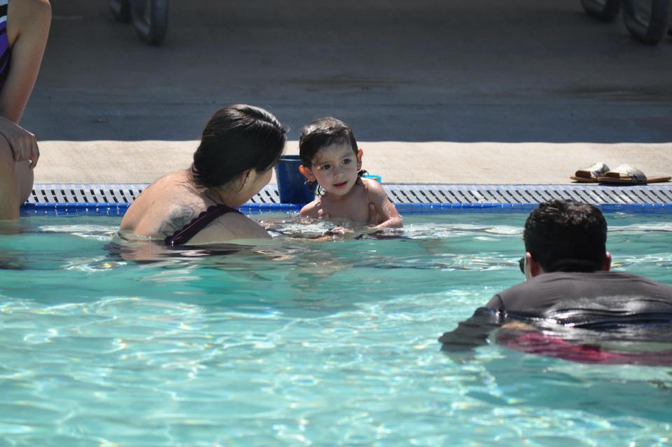 Child with swim instructor in pool
