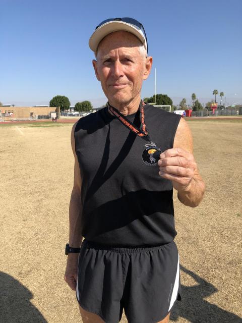 Man Shows His Winning Medal