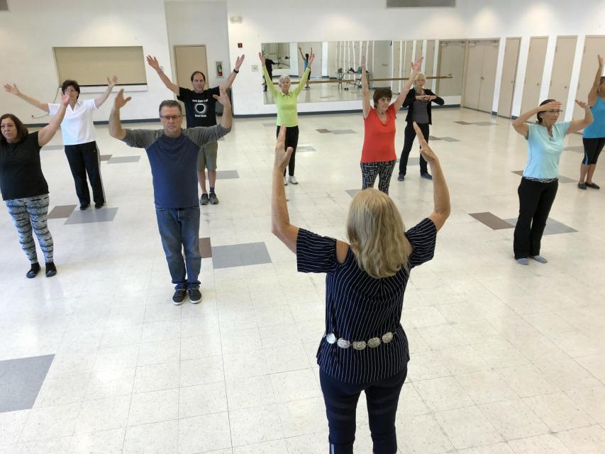 Teacher and students of Tai Chi class indoors