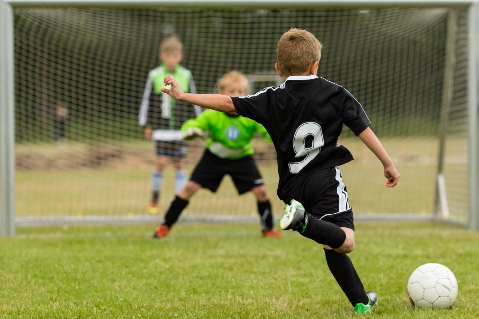 Boys playing outdoor soccer