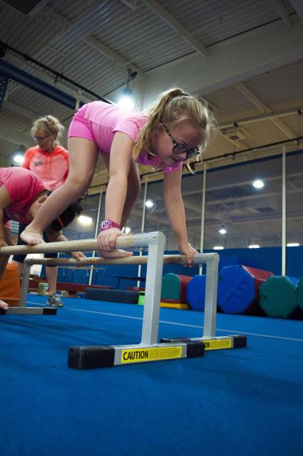 Young girl on gymnastics bars