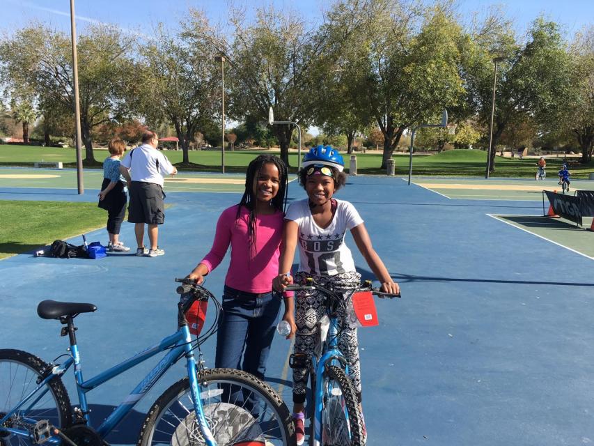 Two girls on bicycles