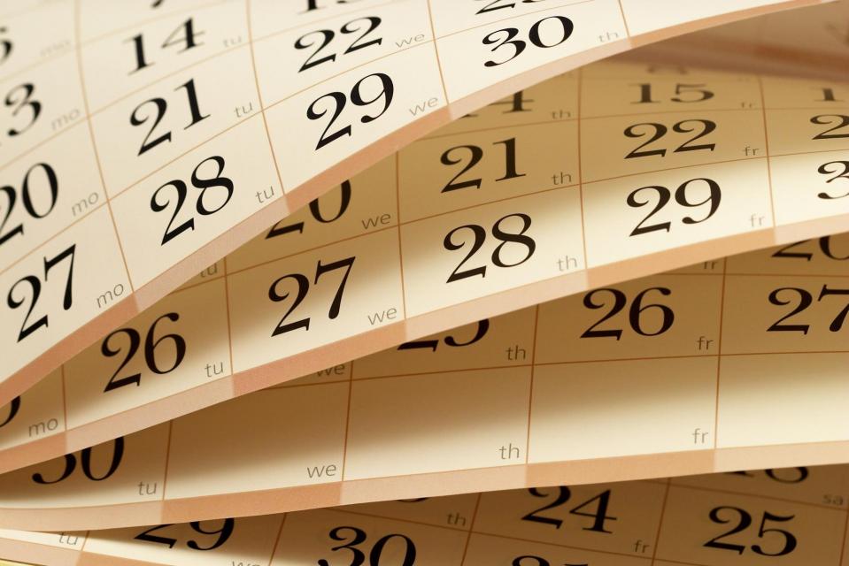 Flipping through months of a paper calendar