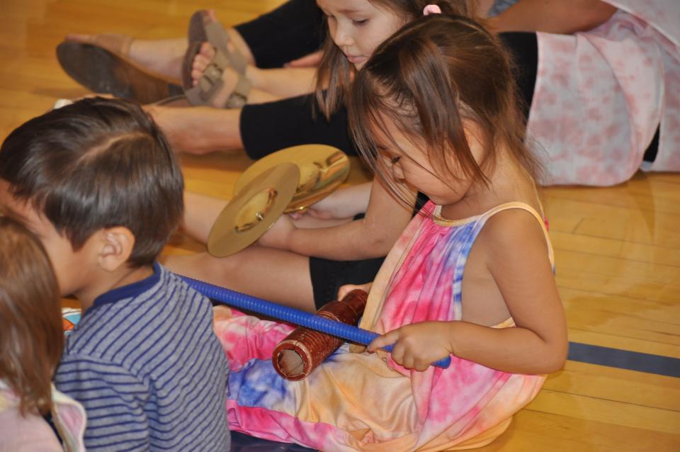 Young children dancing and drumming