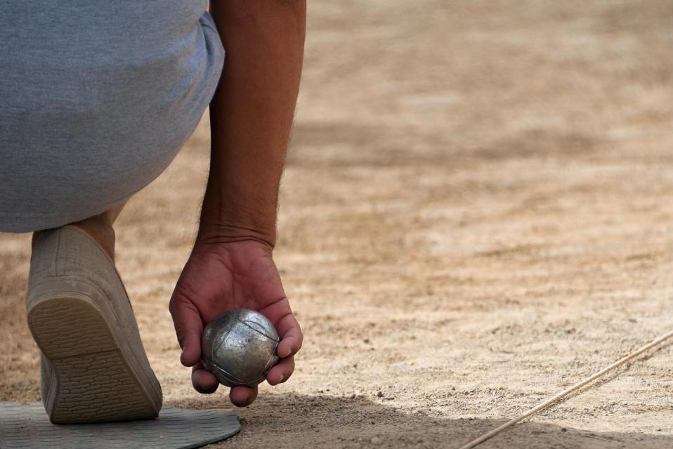 Back of person playing bocce ball