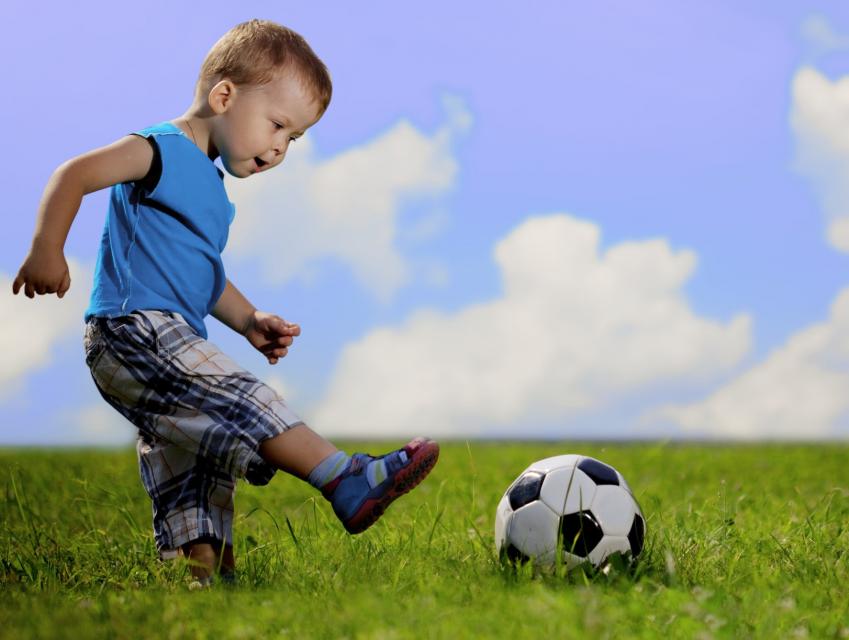Little boy kicking a soccer ball