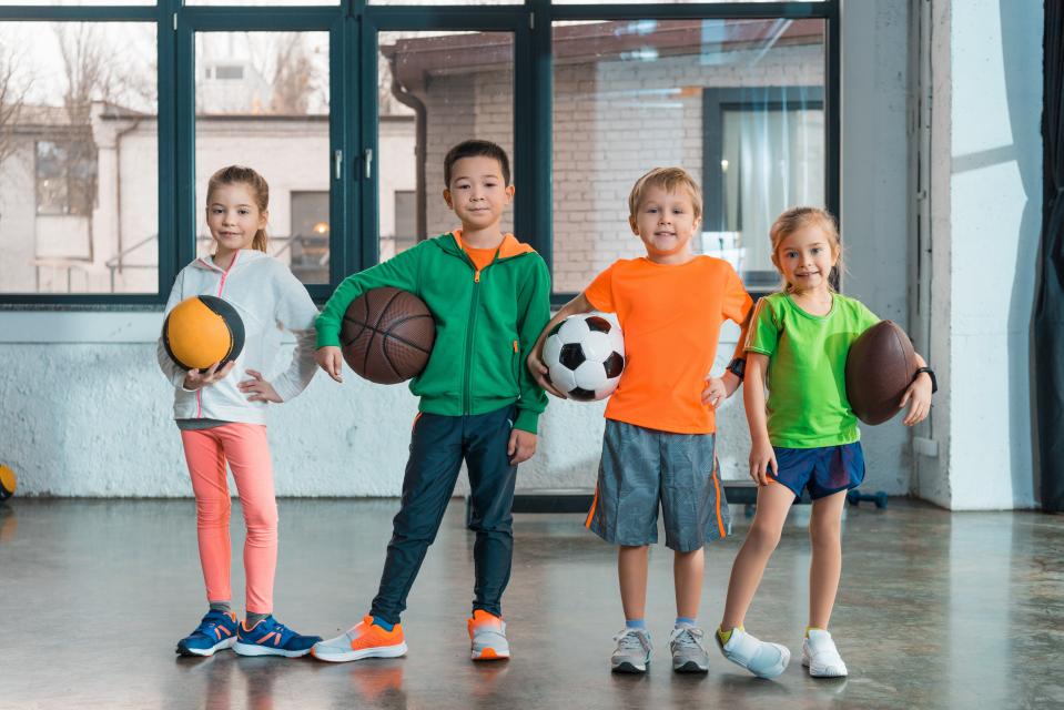 Kids holding sports balls