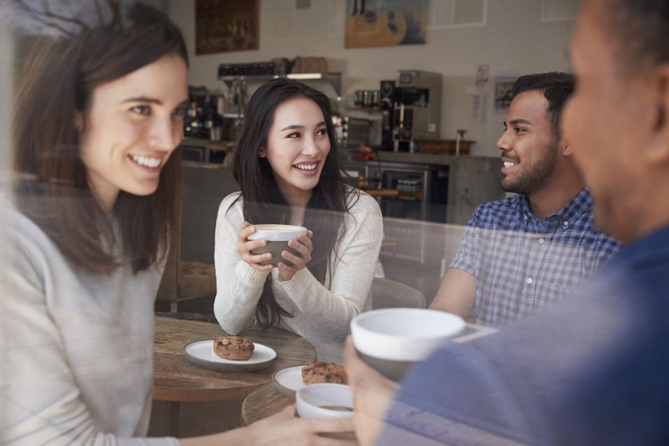 Four adults having coffee