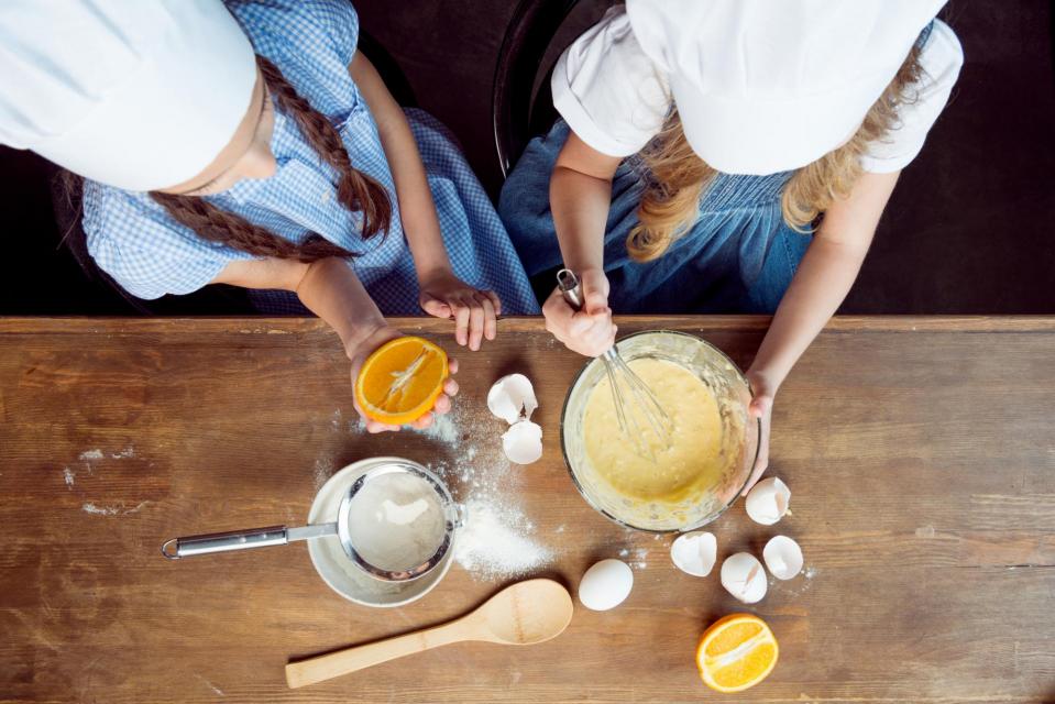 Two youth baking cookies or a cake