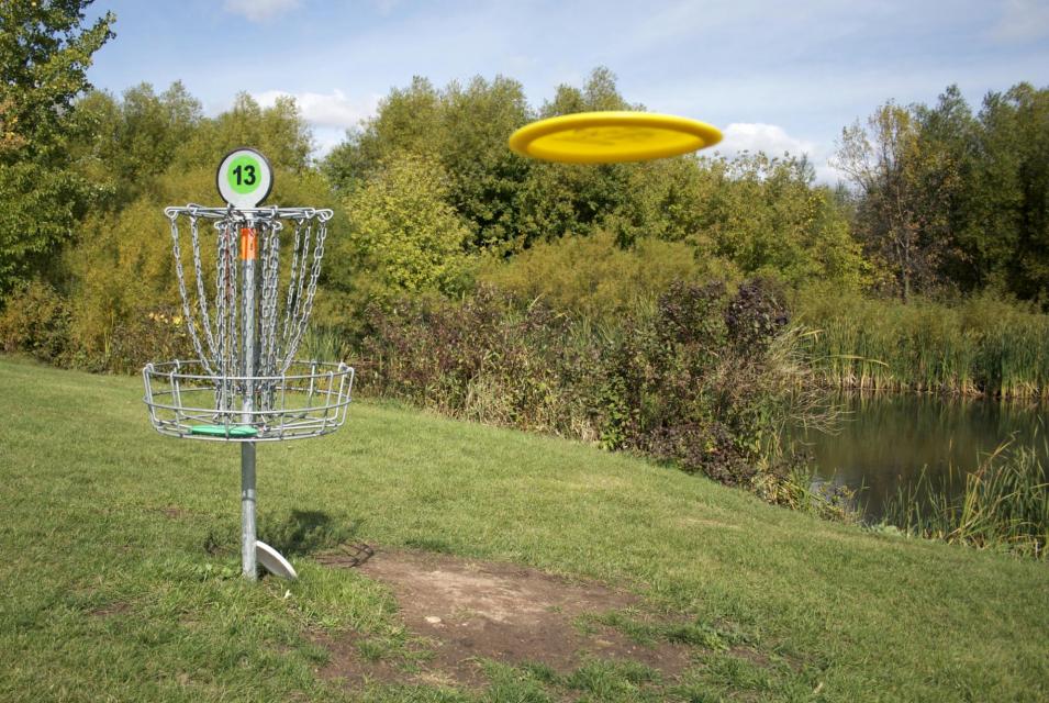 Frisbee headed toward target on simulated golf course