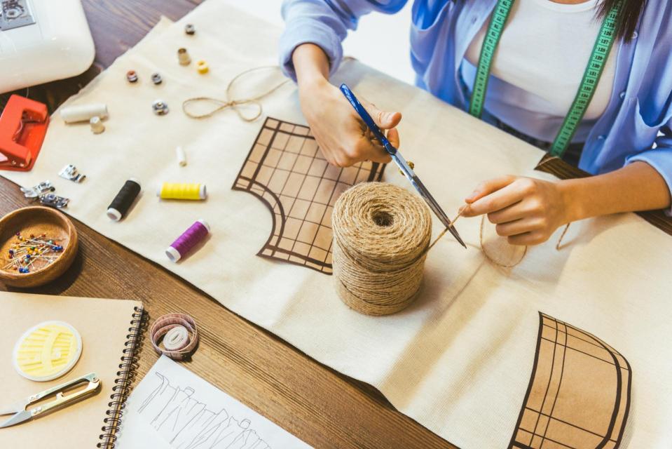 Hands of adult working with craft and sewing supplies
