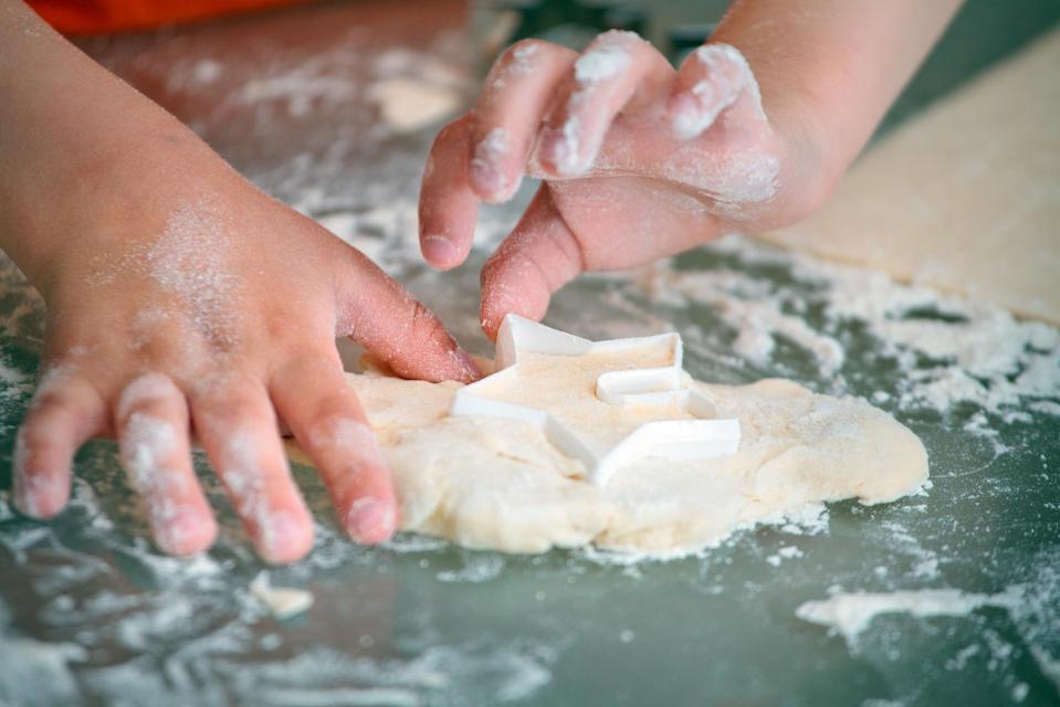 childs hands making dough