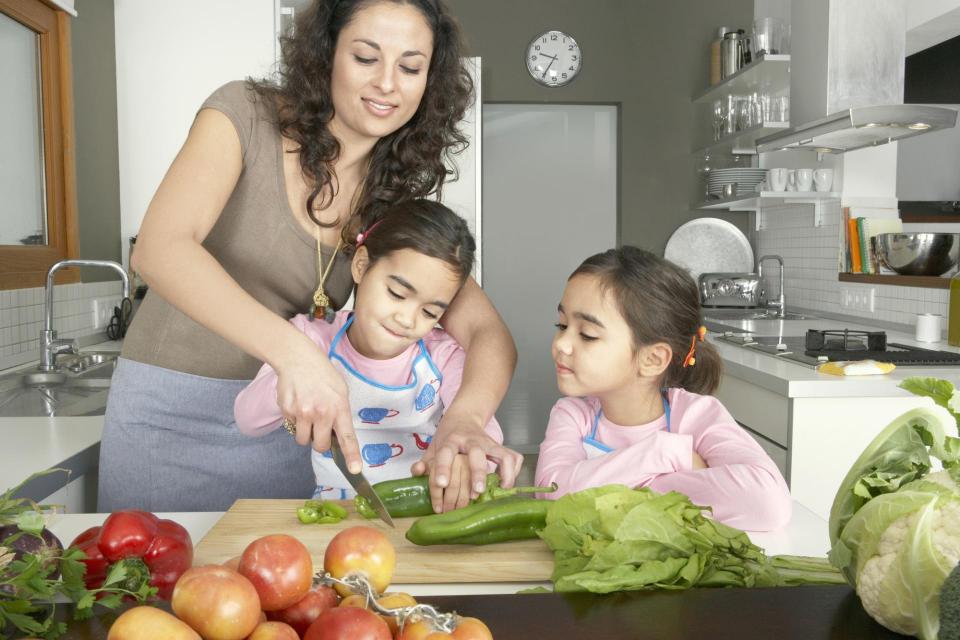 Woman with two girls making healthy foods