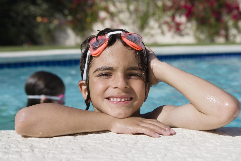 Boy at edge of a swimming pool