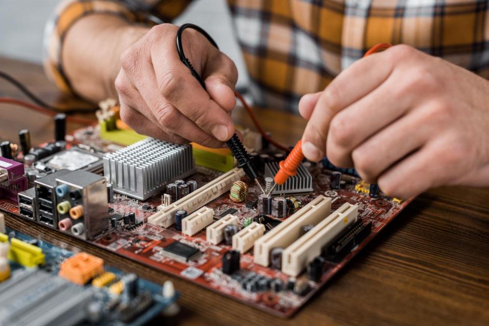 Hands working on a circuit board