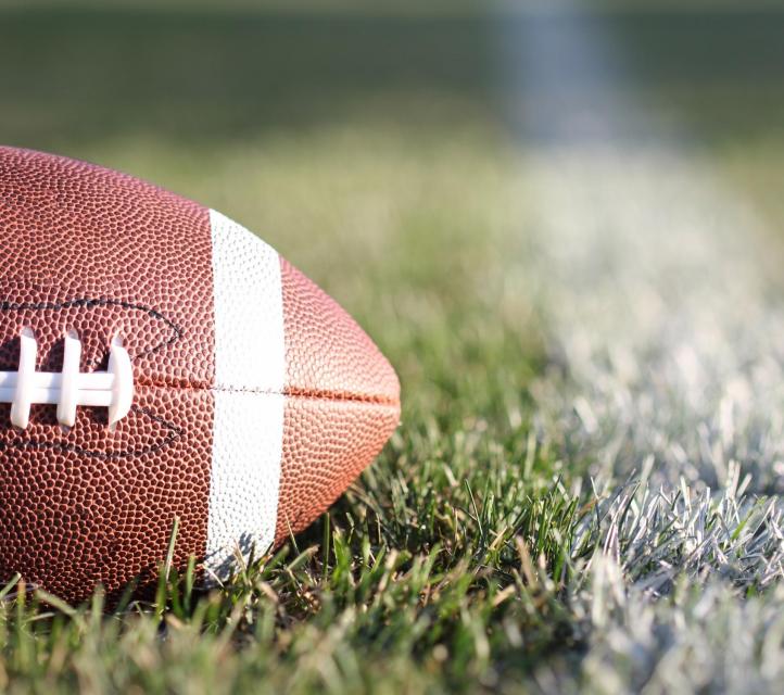 Image of American football on grass