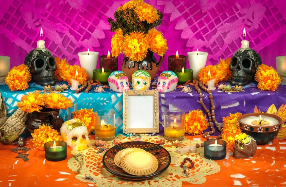 Day of the Dead alter with decorations of skulls, photos etc