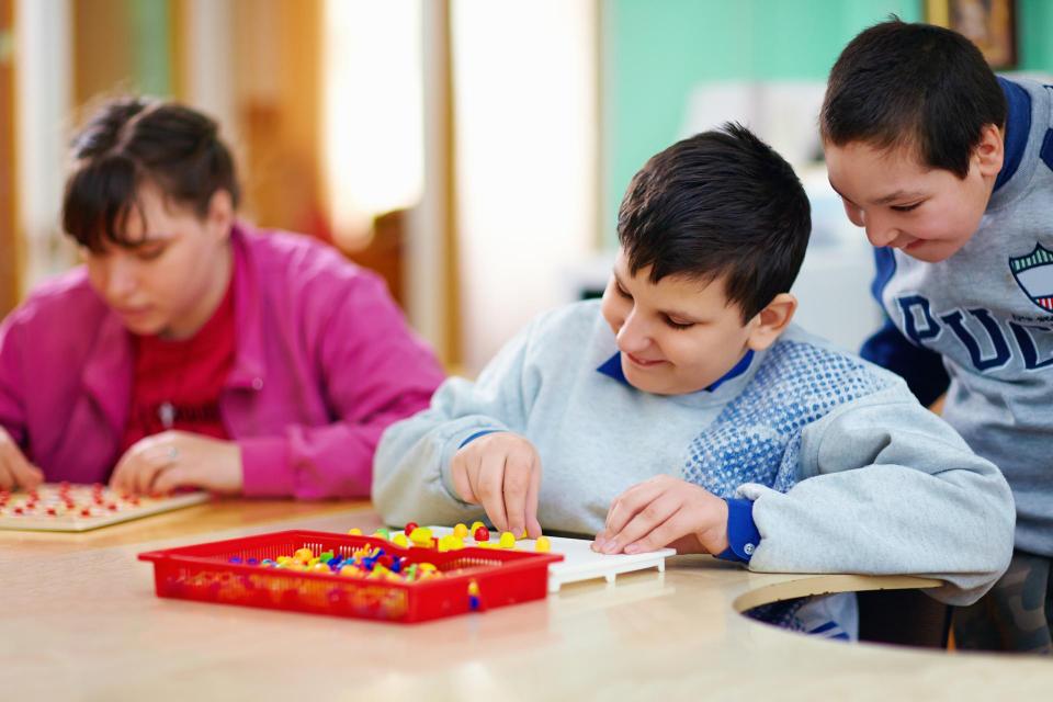 Youth with special needs playing board game