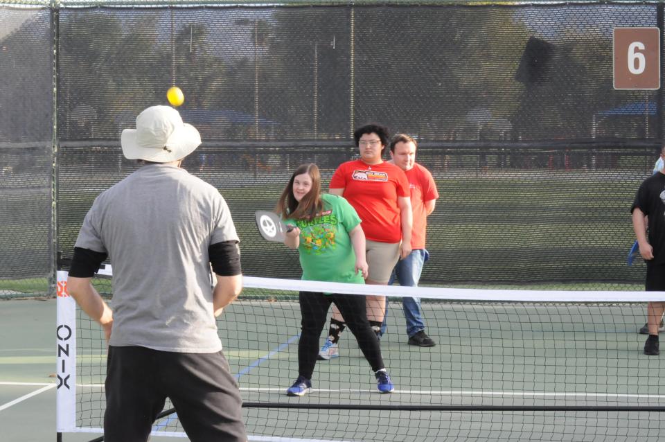 Adults playing adaptive pickleball