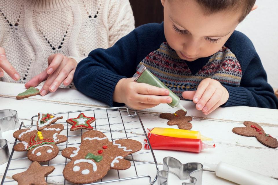 Little boy decorating christmas cookies