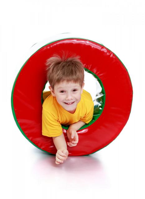 Little boy going through inflatable tunnel