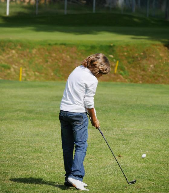Teen playing golf
