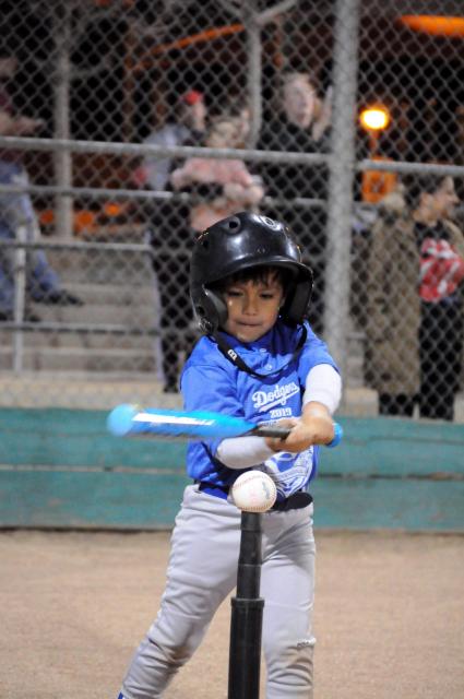 Young boy playing tee ball