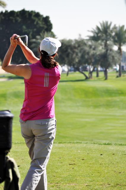 Photo of woman swinging golf club