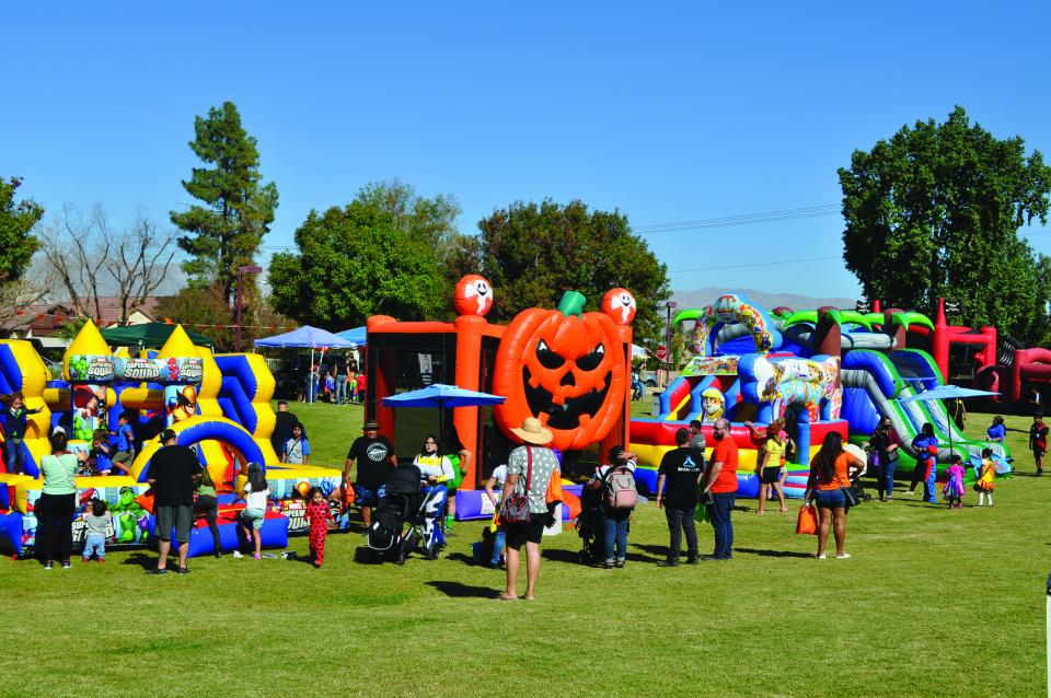 Inflatable bounce house with people at  Halloween carnival