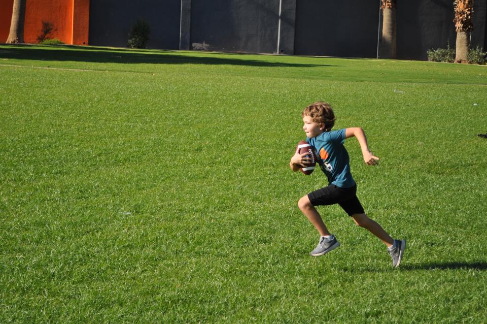 Youth running with football