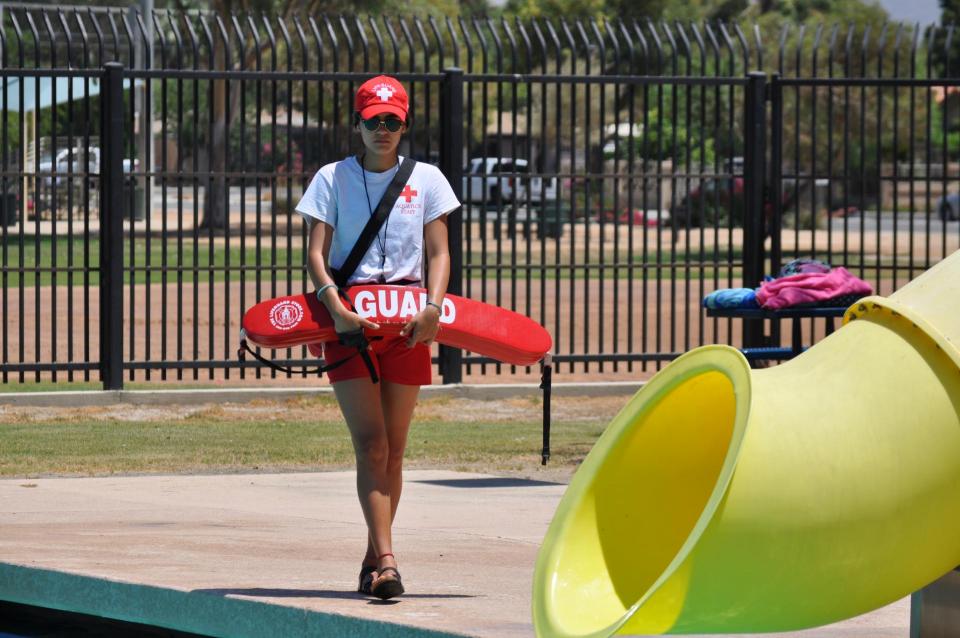 Lifeguard patrolling swimming pool