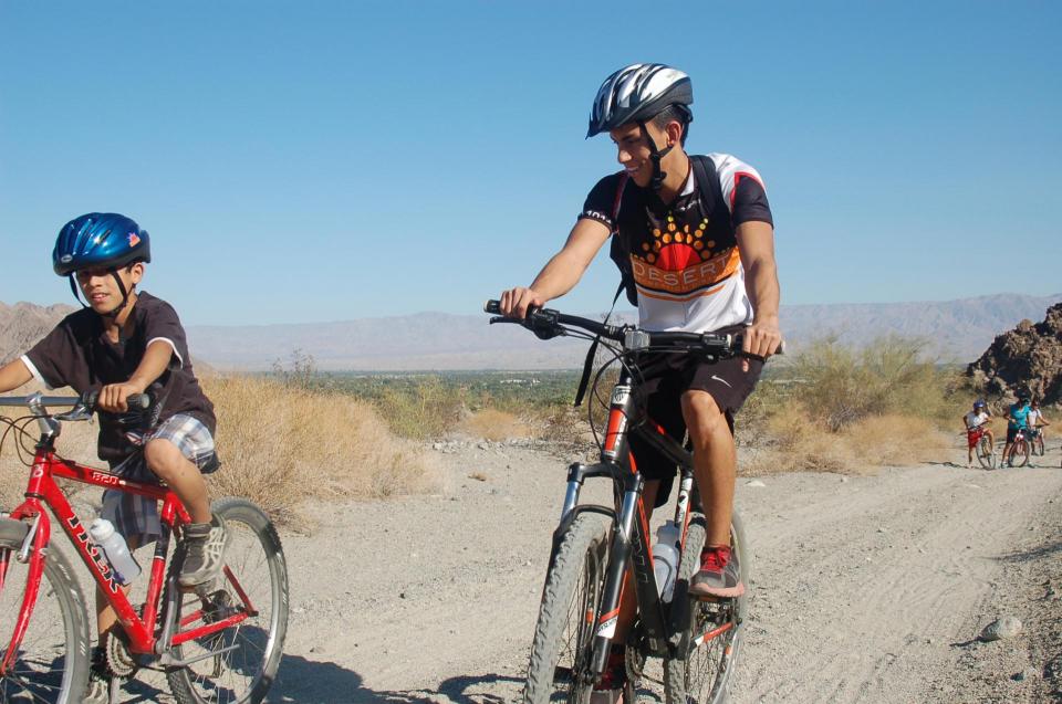 Two people mountain biking in the desert