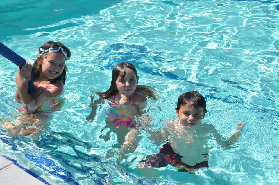 Three children in a pool