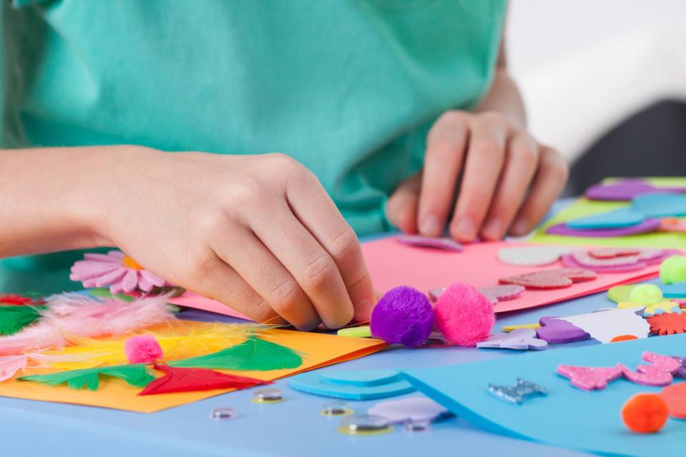 Child's hands making arts & crafts project