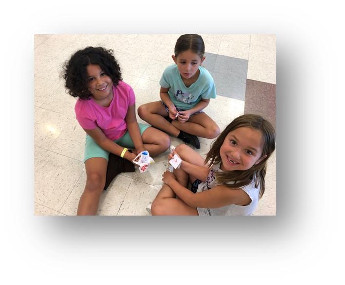 Girls playing on the floor at camp