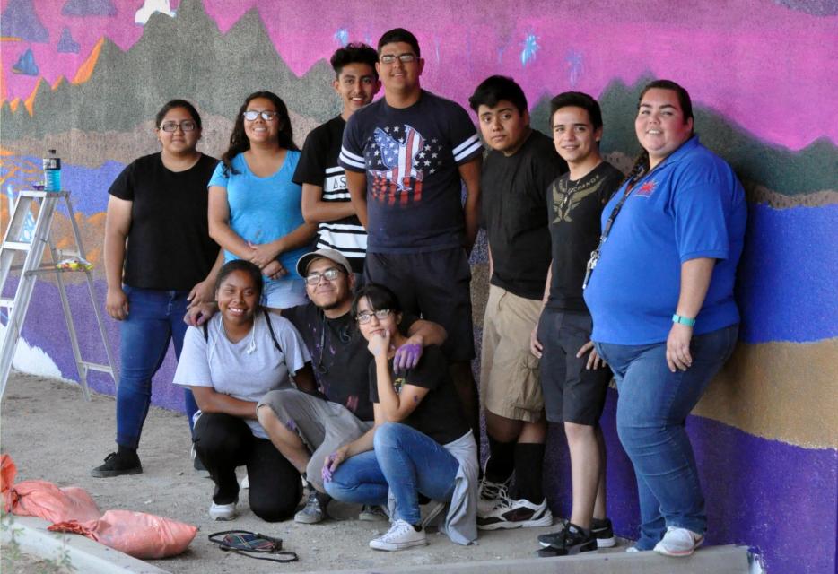 Teens outside building posing for photo