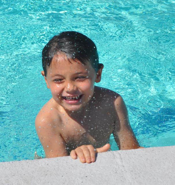 Little boy at the edge of swimming pool