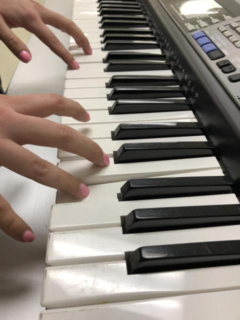 Image of hands playing a keyboard