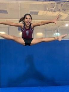 Girl doing splits in the air above trampoline