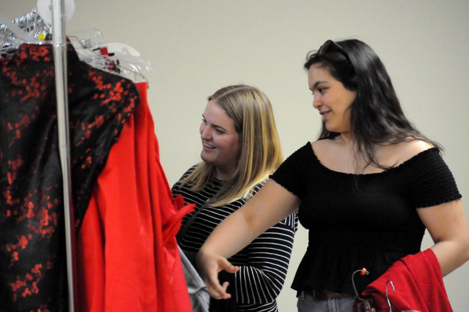 Young ladies browsing clothing racks