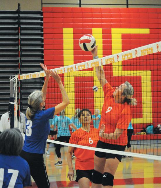 Women playing indoor volleyball