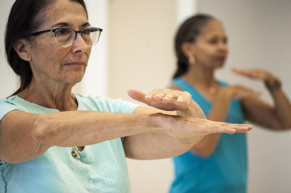 People exercising with tai chi movements